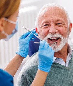 Man smiles at dentist