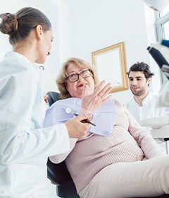 older woman talking to her dentist in a consultation 