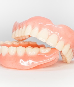 Full set of dentures resting on a white surface