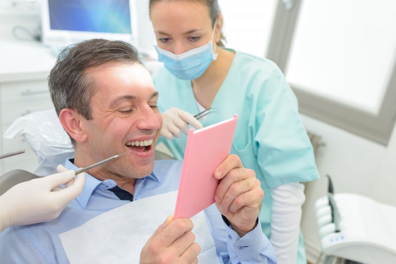 Patient smiling with their dental implants