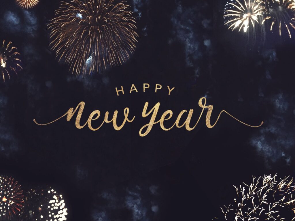 Fireworks with dark background and gold font Happy New Year